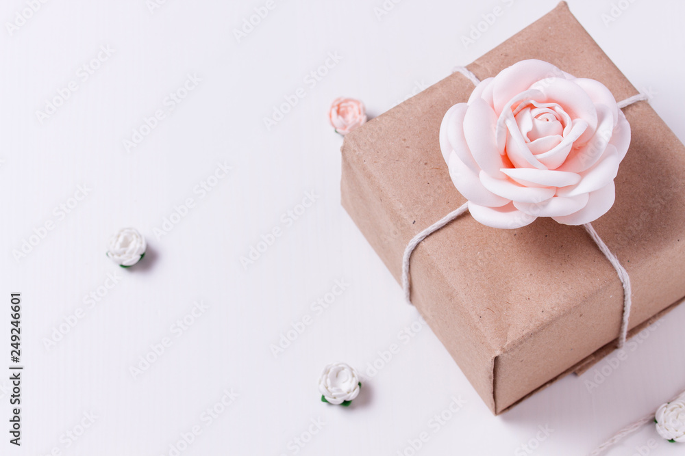 wrapped gift with a rose on a white background. top view copy space wrapped gift with a rose on a white background. top view copy space