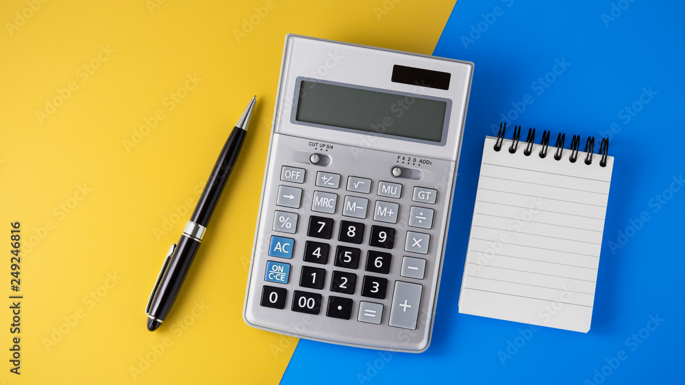 Calculator on vivid yellow and blue background Calculator on vivid yellow and blue background