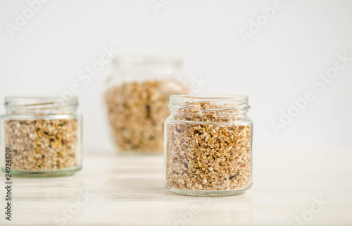 Homemade granola in a glass jar on a white background