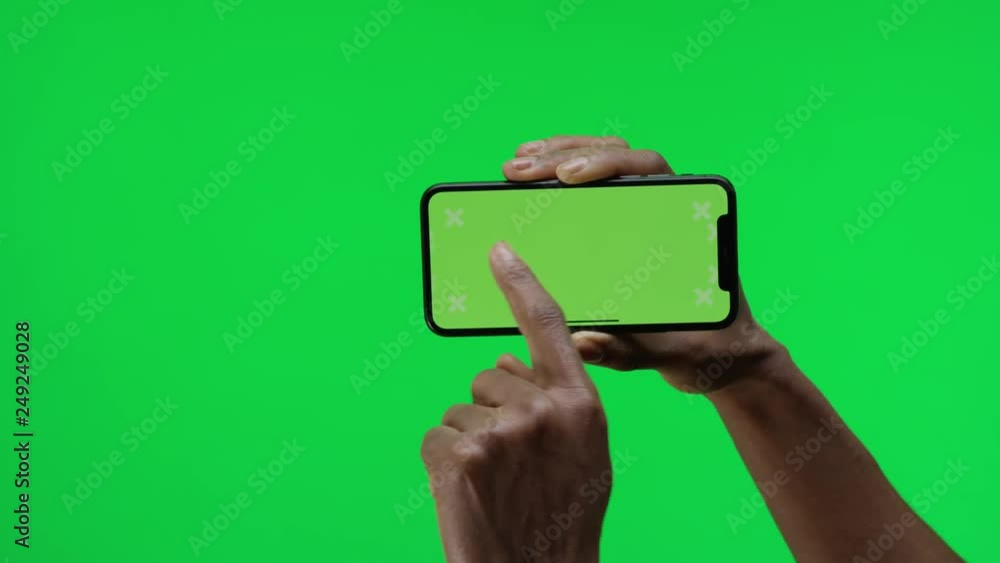 Female hand holding smart device on green screen chroma background making gestures, zoom in, pinch, swipe, scroll Female hand holding smart device on green screen chroma background making gestures, zoom in, pinch, swipe, scroll