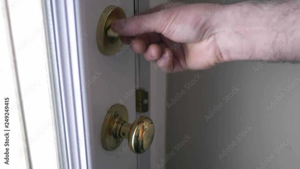 Closing the front door of a house and making sure it is locked. Closing the front door of a house and making sure it is locked.