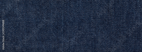 close up, macro shot of raw denim dark wash indigo blue jeans texture for banner background © flukesamed