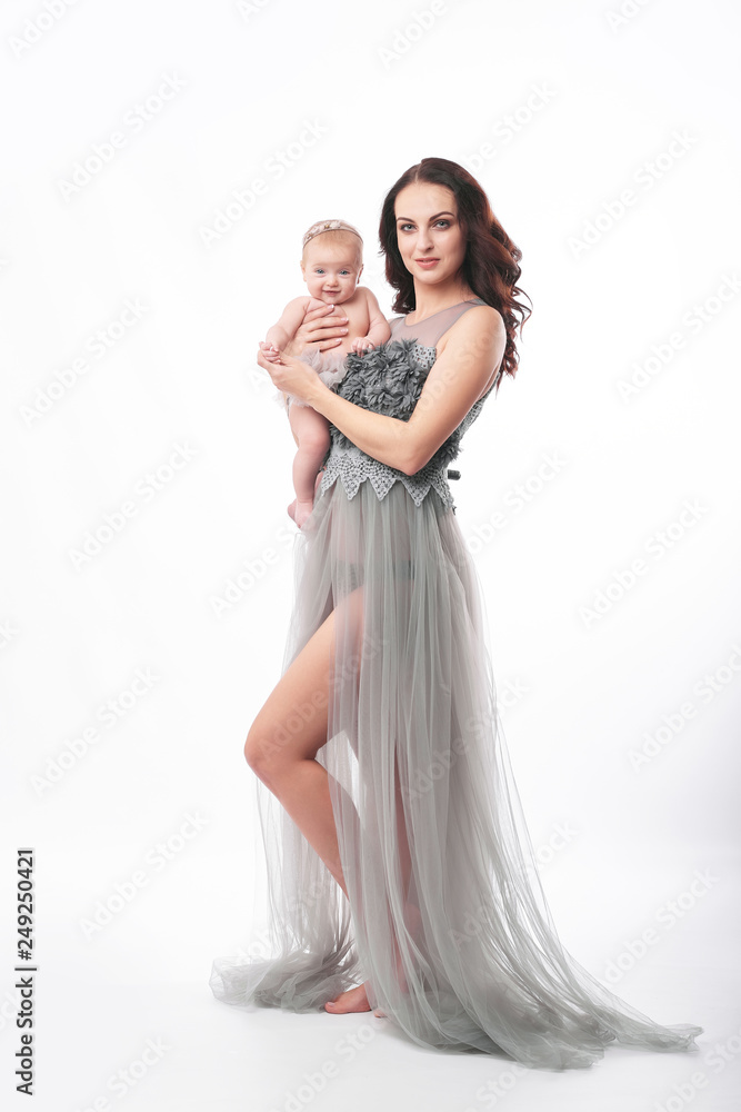 young attractive mother with a little girl on a light background