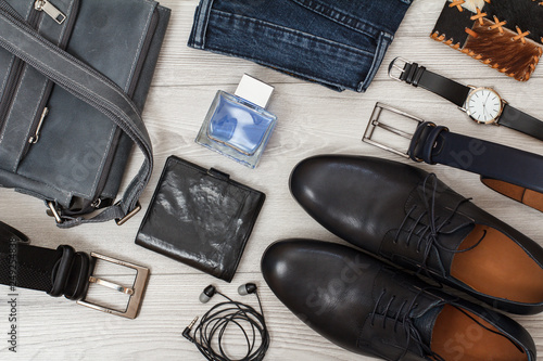 Shoulder bag, pair of black leather men's shoes, belts for men, jeans and accessories.