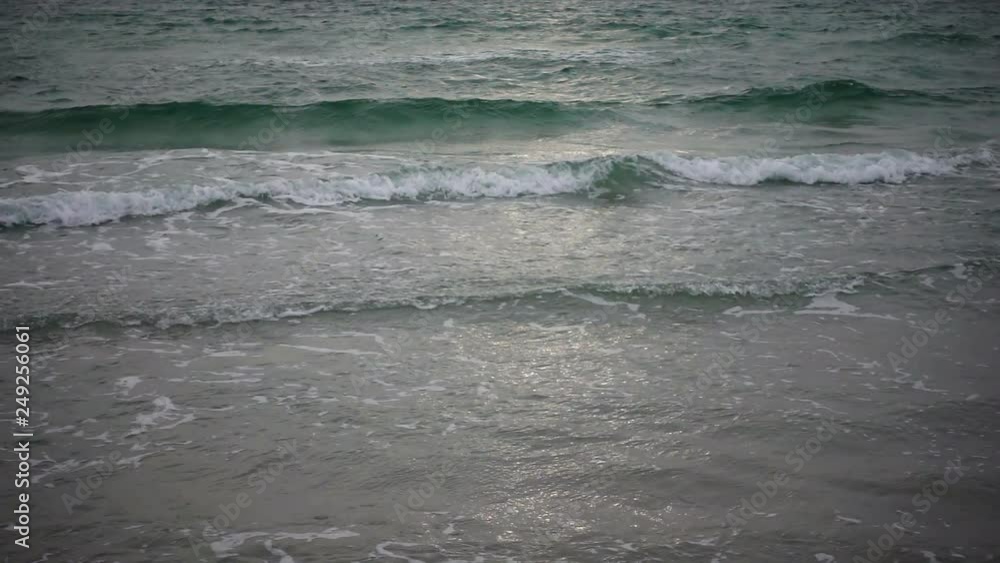 Sea waves in slow motion. Beach, birds and cloudy sky. A little sunset. A relaxing view of the water, slowly overflowing. Sea waves in slow motion. Beach, birds and cloudy sky. A little sunset. A relaxing view of the water, slowly overflowing.