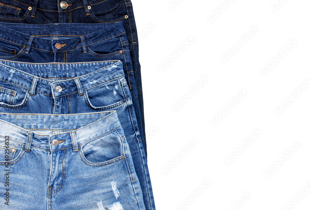Set of different blue jeans isolated on white background top view flat lay.  Detail of nice blue jeans. Jeans texture or denim background. Trend  clothing. Beauty and fashion, clothing concept. Stock Photo