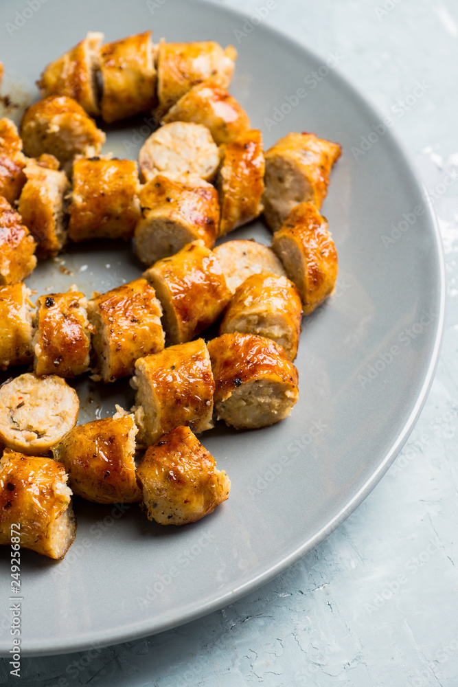 Grilled sliced sausages on plate with classic mustard sauce. Selective focus. Shallow depth of field. Grilled sliced sausages on plate with classic mustard sauce. Selective focus. Shallow depth of field.