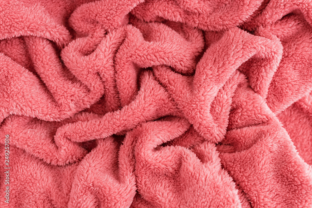 Close up top view of coral blanket wrinkled texture. Fluffy coral background. Close up top view of coral blanket wrinkled texture. Fluffy coral background.