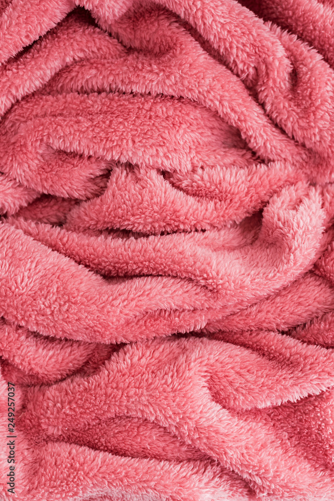 Close up top view of coral blanket wrinkled texture. Fluffy coral background. Close up top view of coral blanket wrinkled texture. Fluffy coral background.