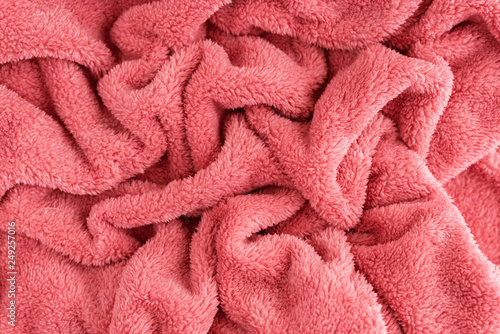 Close up top view of coral blanket wrinkled texture. Fluffy coral background. photo