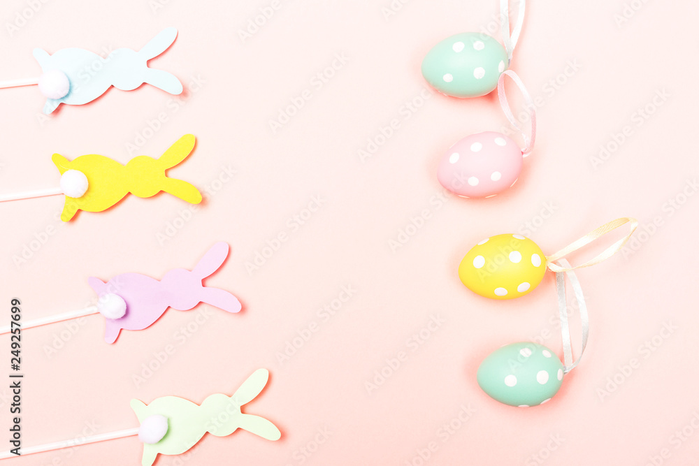 Easter bunnies on pastel pink background
