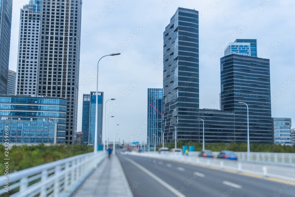Fototapeta premium road through the bridge with city skyline background.