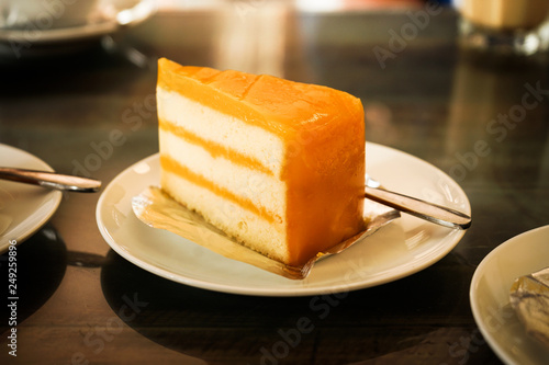 Fruit orange cake on white plate dressert eat with coffee relax time in resturant photo