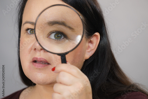 Adult woman with magnifying glass