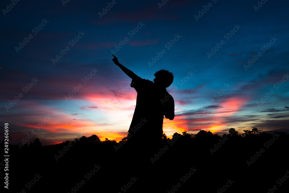Silhouette of a male holding hands at sunrise. Silhouette of a male holding hands at sunrise.