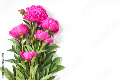 Bouquet of romantic pink peony flowers on white. Copy space. Top view.