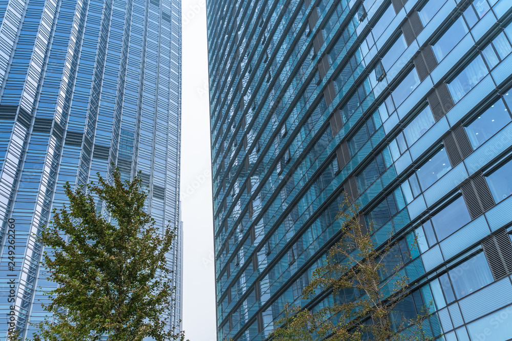 modern office building with green trees. modern office building with green trees.