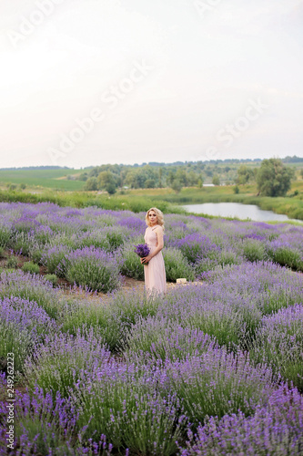 Pretty girl in a lavender field .