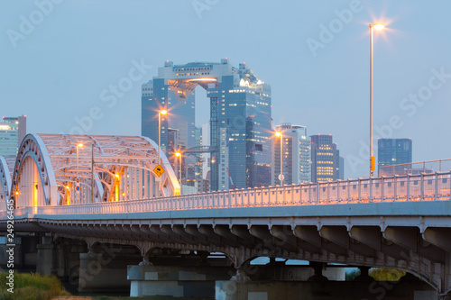 Landscape of osaka city at Umeda from across the Yodogawa River. photo