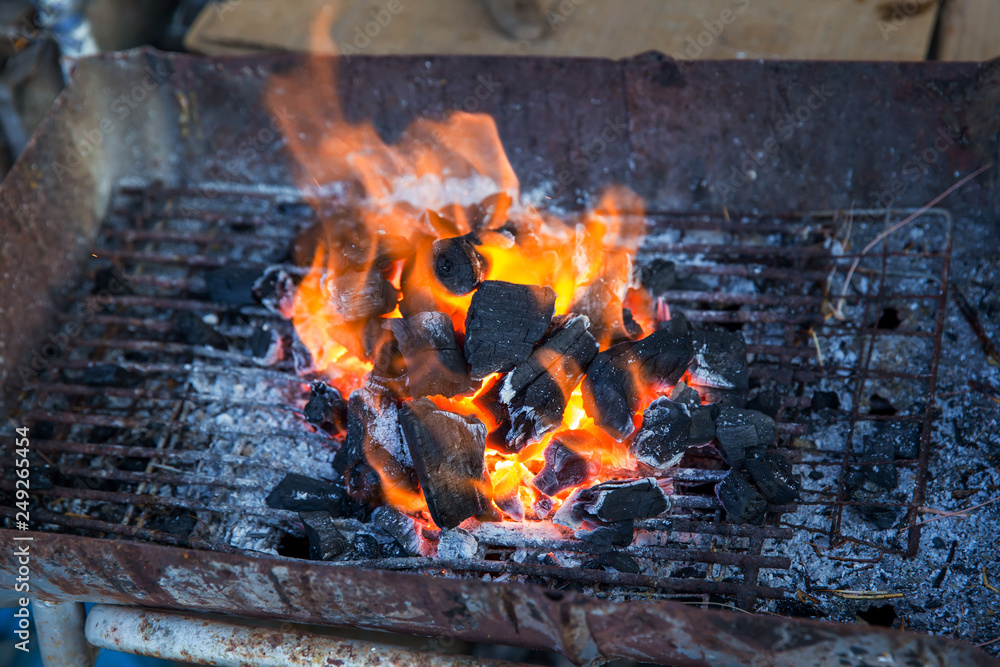 Stove charcoal.orange flames of coals in the grill / Charcoal stove burning.Brazier charcoal burning ready to grill in solid stove,feel cliam and warm at night. Stove charcoal.orange flames of coals in the grill / Charcoal stove burning.Brazier charcoal burning ready to grill in solid stove,feel cliam and warm at night.