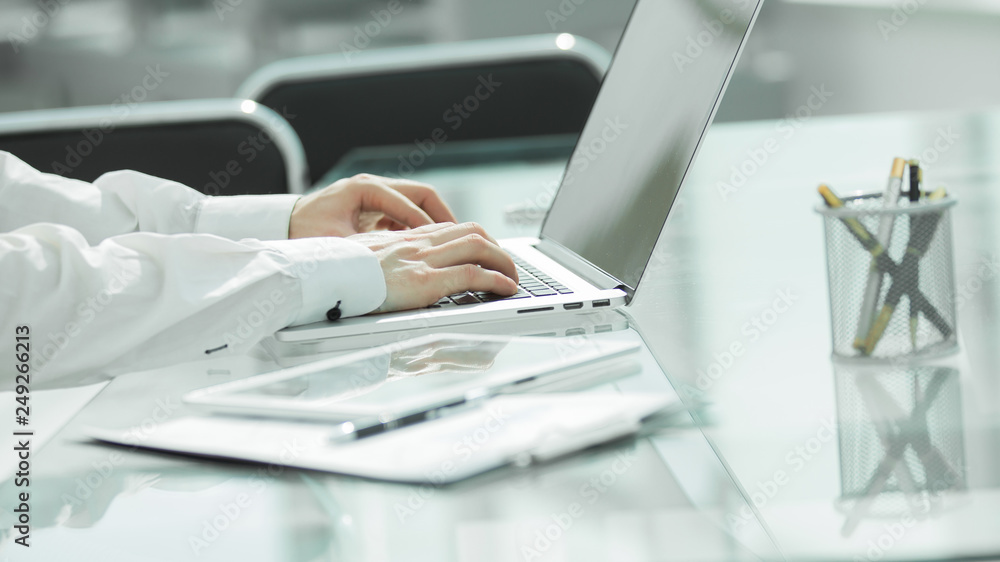 close up. businessman typing on a laptop close up. businessman typing on a laptop