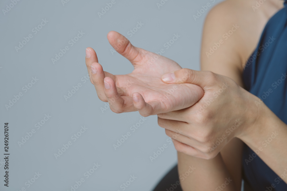 Close up hand of business woman holding her painful wrist caused by prolonged work on the computer, laptop. Office syndrome neurological disease concept.Free from copy space. Close up hand of business woman holding her painful wrist caused by prolonged work on the computer, laptop. Office syndrome neurological disease concept.Free from copy space.