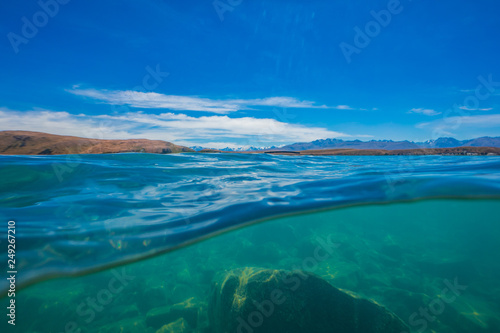 half over half under the water surface at lake tekapo in New Zealand, over and under the lake takepo, Lake Tekapo, South Island, New Zealand 