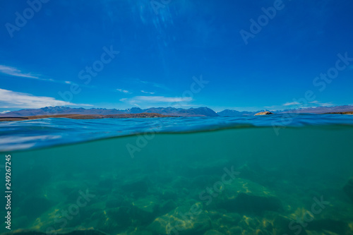 half over half under the water surface at lake tekapo in New Zealand  over and under the lake takepo  Lake Tekapo  South Island  New Zealand 