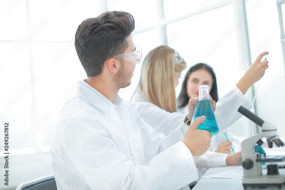 male researcher carrying out scientific research in a lab male researcher carrying out scientific research in a lab