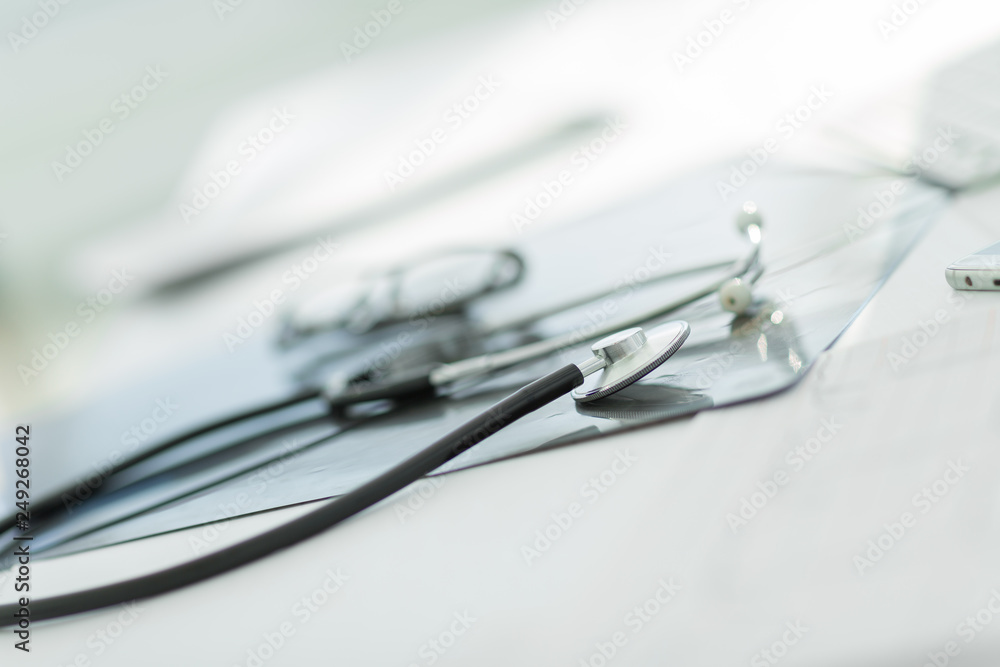 close up. glasses and a stethoscope on the therapist's Desk close up. glasses and a stethoscope on the therapist's Desk