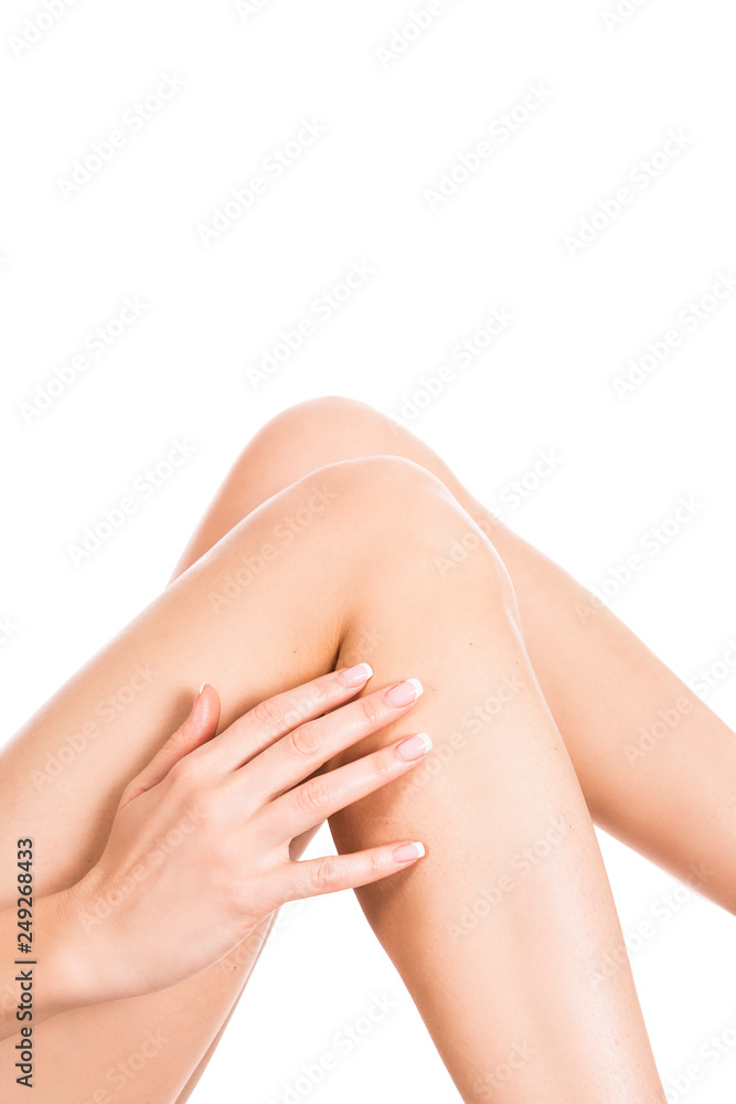 Fototapeta premium Well-groomed female legs after depilation isolated on white background. Skin care concept