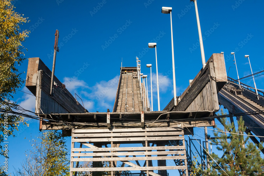 Abandoned wooden ski jumping hill on blue sky background in Kouvola, Finland Abandoned wooden ski jumping hill on blue sky background in Kouvola, Finland