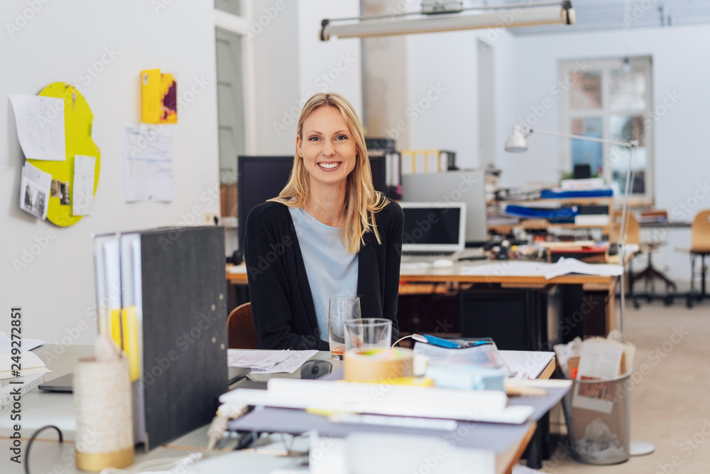 Happy young woman portrait in open space office Happy young woman portrait in open space office