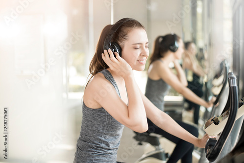 Pretty young sport woman is exercise on bicycle in gym, Healthy lifestyle