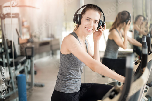 Pretty young sport woman is exercise on bicycle in gym, Healthy lifestyle