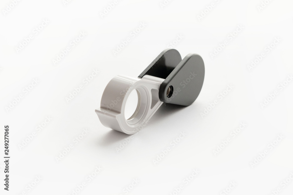 Magnifying glass for diamonds or see the amulet Isolated on a White Background. Magnifying glass for diamonds or see the amulet Isolated on a White Background.