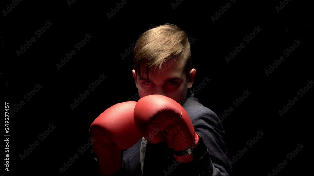 a young man of Caucasian appearance in the business costumes confident and throws his hands and is preparing for a Boxing match