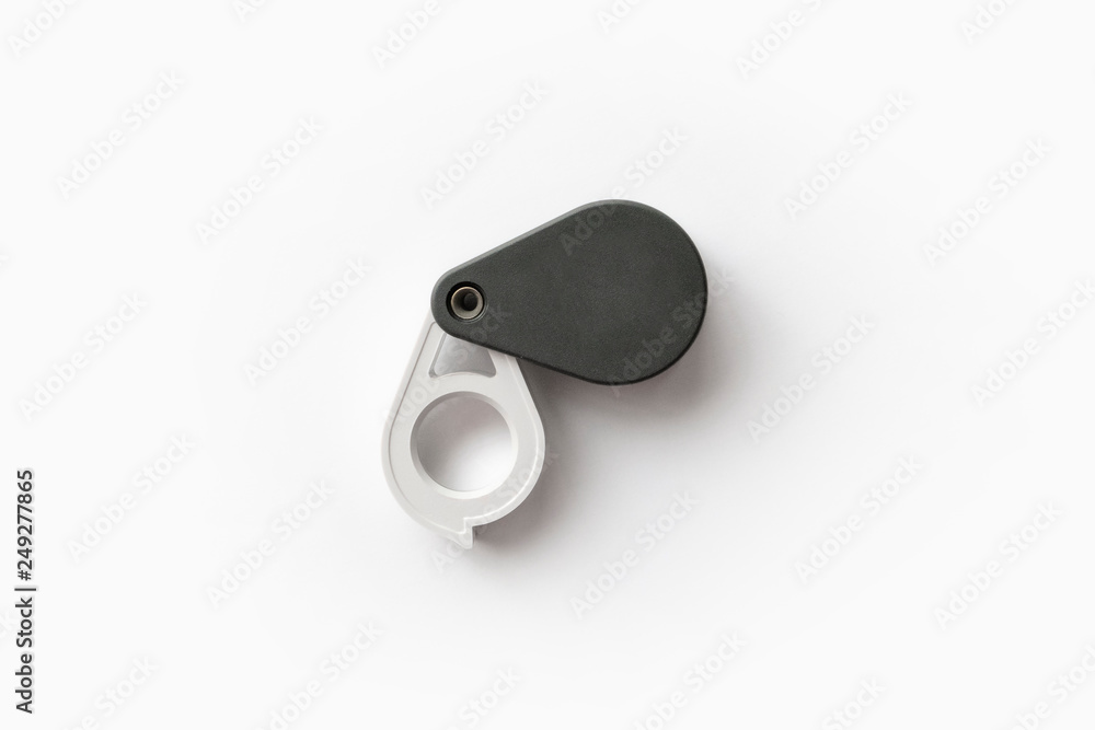 Magnifying glass for diamonds or see the amulet Isolated on a White Background. Magnifying glass for diamonds or see the amulet Isolated on a White Background.