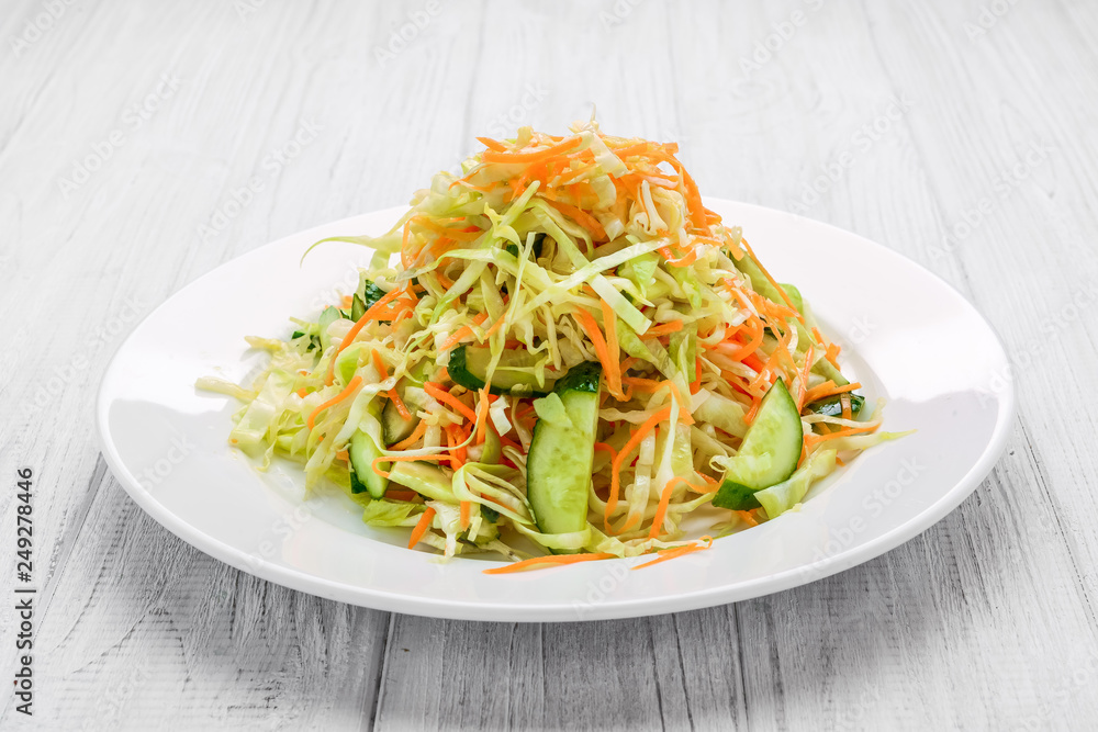 Fresh vegetable salad with cabbage, carrot, green onion and cucumber Fresh vegetable salad with cabbage, carrot, green onion and cucumber