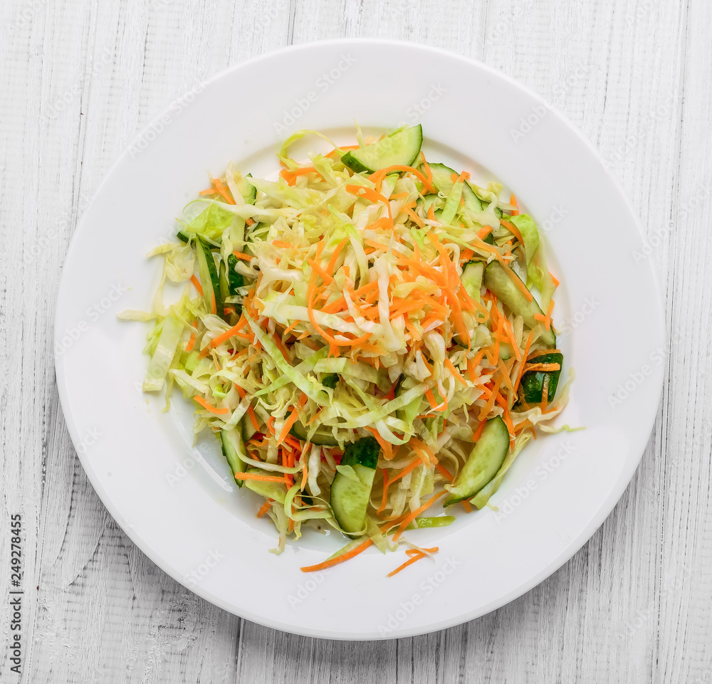 Fresh vegetable salad with cabbage, carrot, green onion and cucumber Fresh vegetable salad with cabbage, carrot, green onion and cucumber