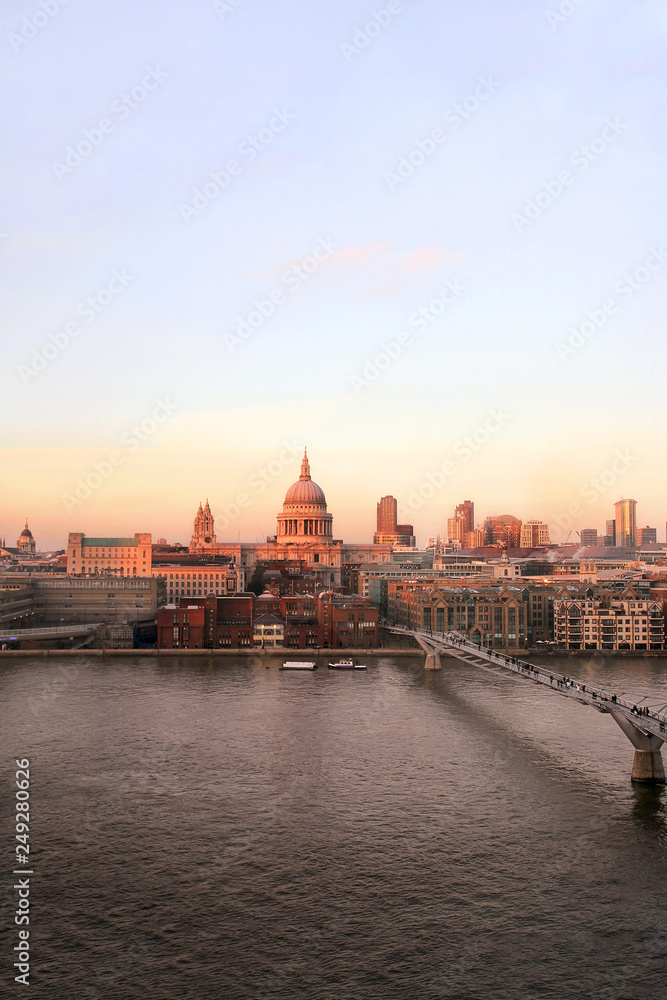 Naklejka premium Sunset view of St Paul's Cathedral and Millennium Bridge