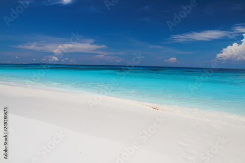 Beautiful gentle wave at tropical beach with clear sky