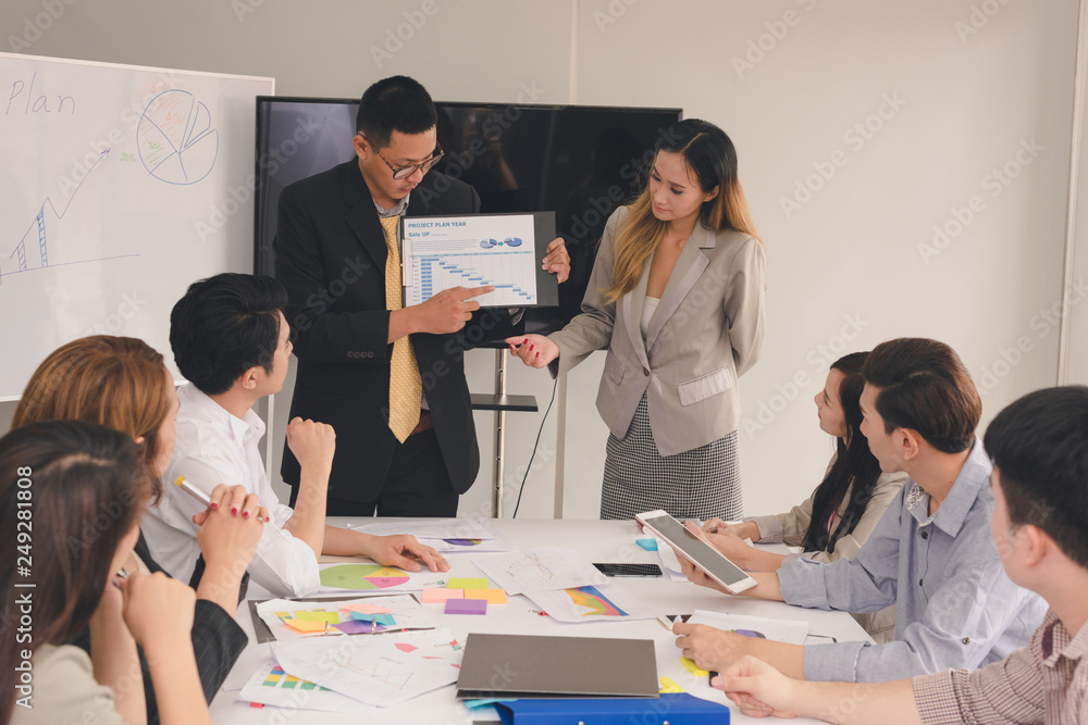 A group of Asian businessmen are discussing their work.The president and secretary presentations to the employees. A group of Asian businessmen are discussing their work.The president and secretary presentations to the employees.