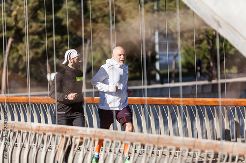 Two mature men running