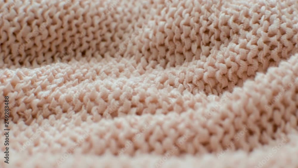 The texture of the fabric. Pink knitted texture. Close-up. Can be used as a background. HD The texture of the fabric. Pink knitted texture. Close-up. Can be used as a background. HD