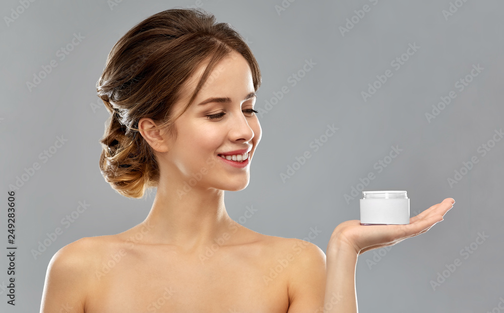 beauty, cosmetics and skincare concept - happy young woman holding jar of cream over grey background beauty, cosmetics and skincare concept - happy young woman holding jar of cream over grey background
