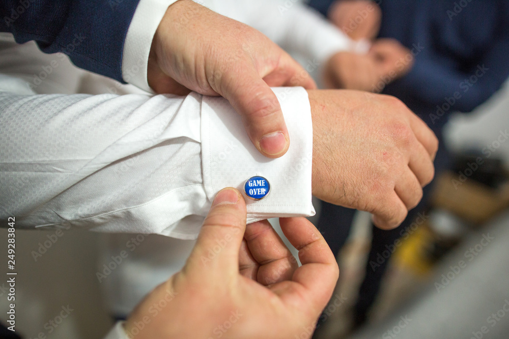 Fototapeta premium Groomsmen prepare groom for wedding