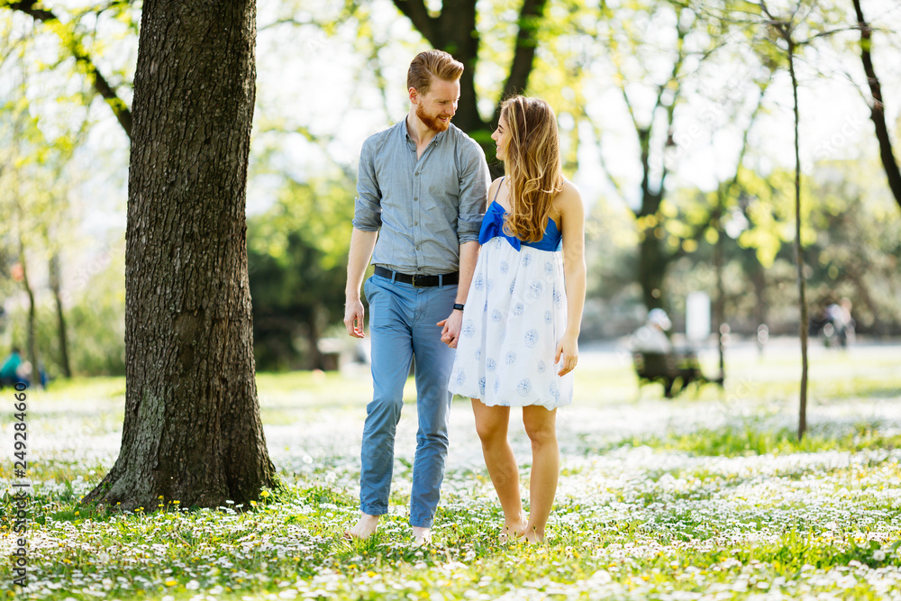 Fototapeta premium Beautiful couple taking a walk in city park