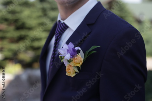 pink rose and lilac iris boutonniere