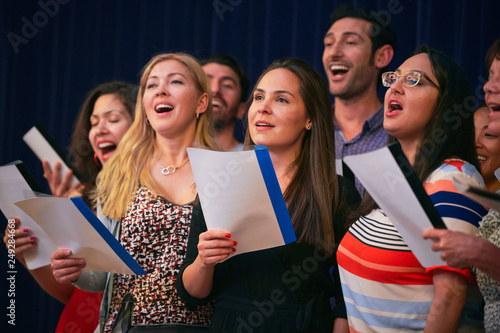 Multi-ethnic friends singing at choir practice in language school